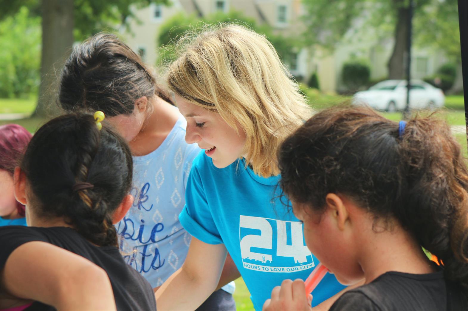 Several teenagers talking and looking at a group activity