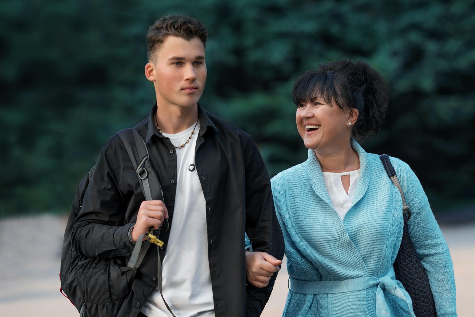 Mother and teenage  son walking beside one another