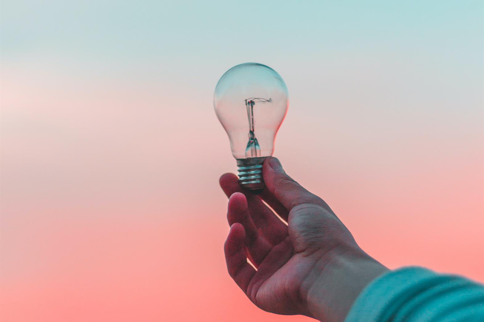 person holding lightbulb