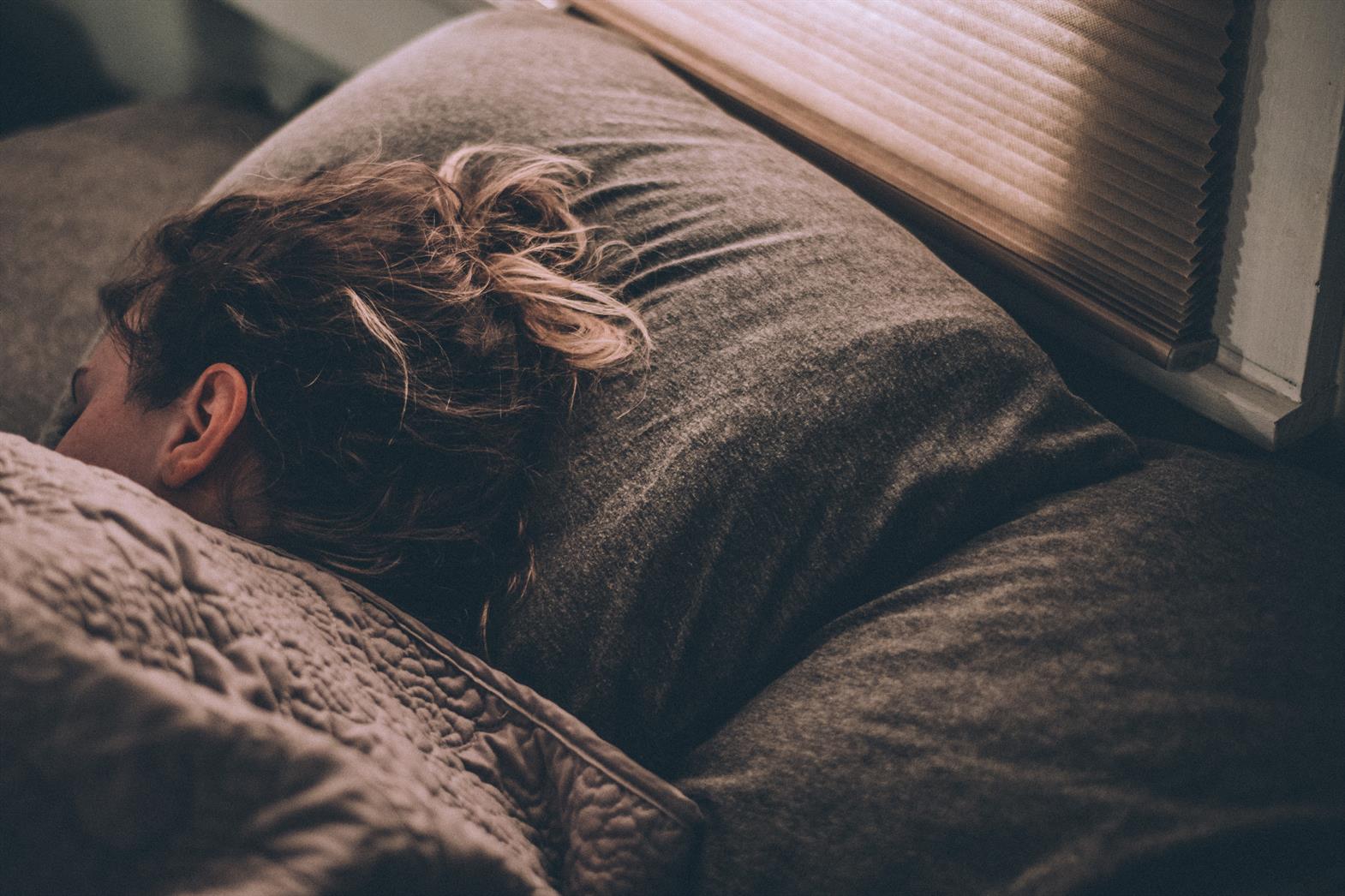 woman sleeping on bed