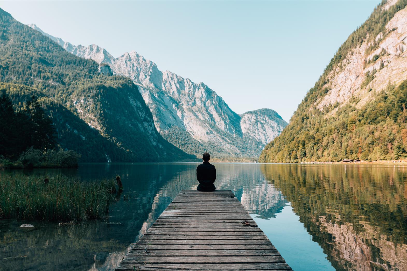 Young man looking at a lake