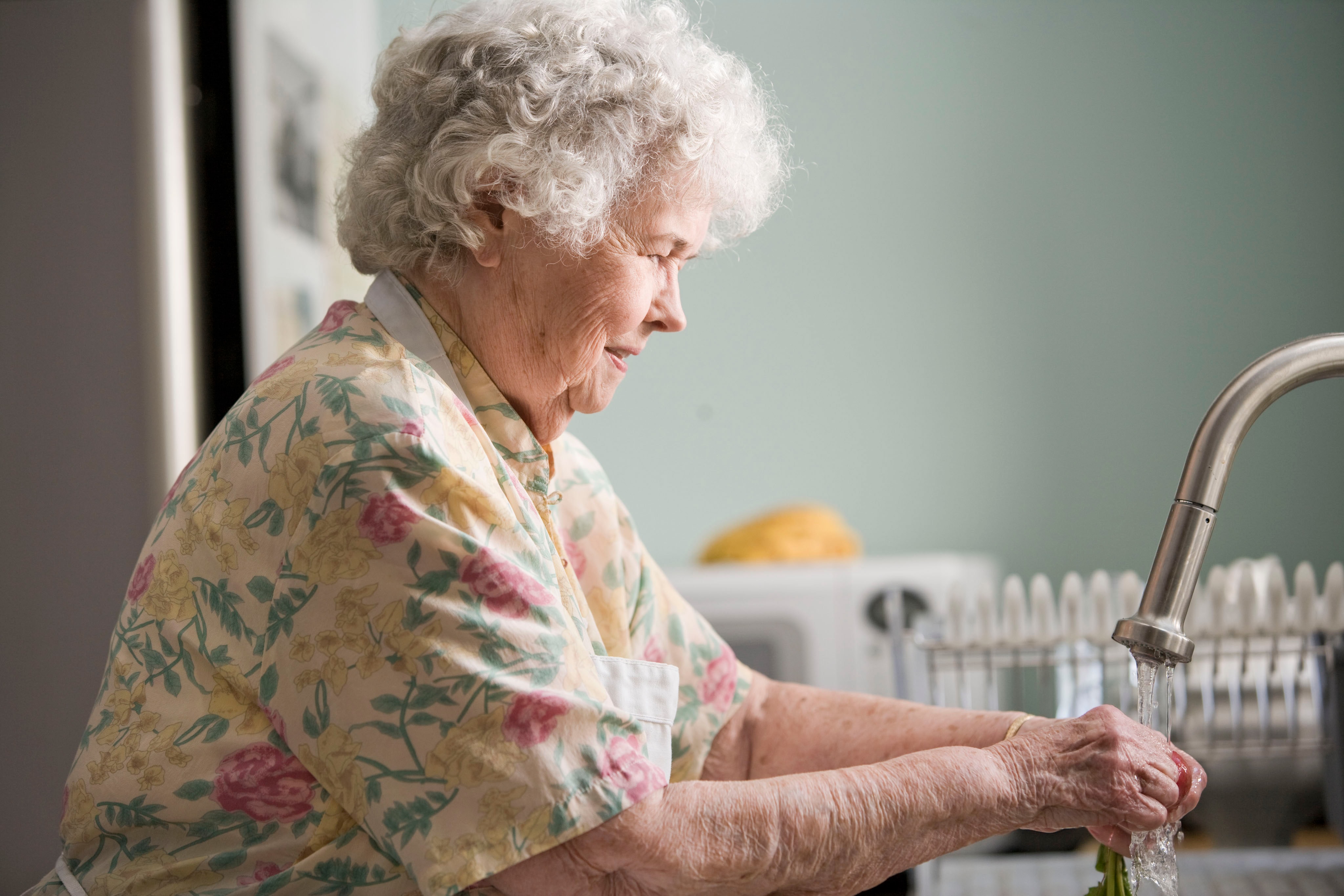 Senior woman washing her hands