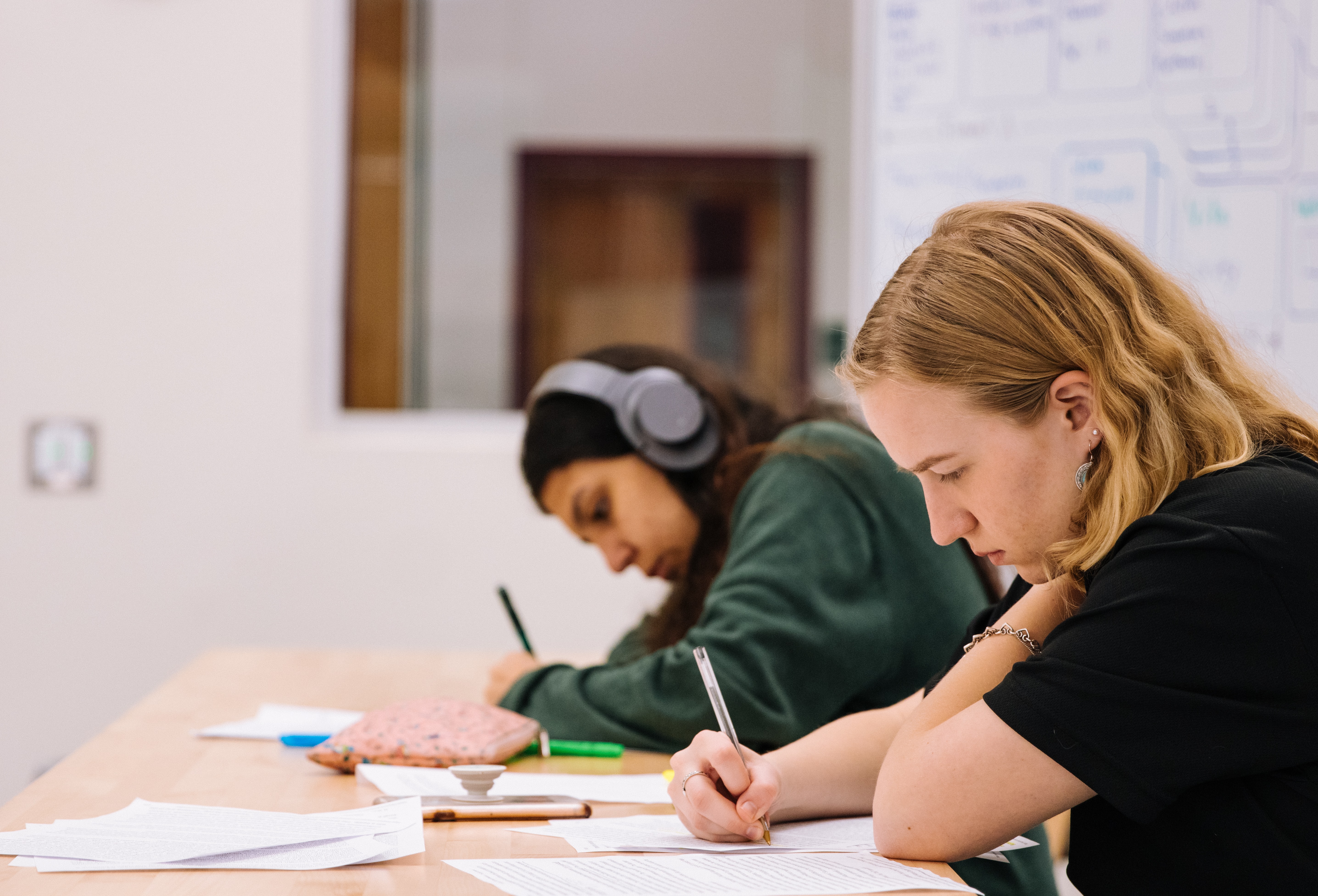 teen writing in school